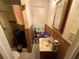 Compact bathroom with toilet, sink, shower, and floral wallpaper accents at 1268 Woodland Ne Rd, Conyers, GA 30012