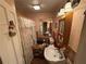 This bathroom features wallpaper, floral shower curtain, and single bowl sink at 1268 Woodland Ne Rd, Conyers, GA 30012