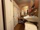Vintage bathroom with wallpaper, floral shower curtain, and double bowl sink at 1268 Woodland Ne Rd, Conyers, GA 30012