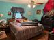 Charming bedroom with bright walls, natural lighting, a comfortable bed and a carved bench at 1268 Woodland Ne Rd, Conyers, GA 30012