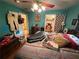 This cozy bedroom features striped bedding, ceiling fan, and eclectic decor at 1268 Woodland Ne Rd, Conyers, GA 30012