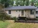 View of front entry with small garden at 1268 Woodland Ne Rd, Conyers, GA 30012