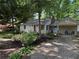 View of exterior with driveway and cute chairs on a small porch at 1268 Woodland Ne Rd, Conyers, GA 30012