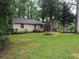 Well-maintained lawn and landscaped front yard at 1268 Woodland Ne Rd, Conyers, GA 30012