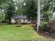 Charming home with lush lawn, mature trees, and well-maintained landscaping at 1268 Woodland Ne Rd, Conyers, GA 30012
