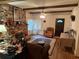 Living room featuring exposed beam ceilings and brick fireplace at 1268 Woodland Ne Rd, Conyers, GA 30012