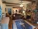 Cozy living room featuring hardwood floors, exposed beam ceilings, and a brick fireplace at 1268 Woodland Ne Rd, Conyers, GA 30012