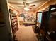Living room with wooden paneling, neutral carpet, and vintage cabinets at 1268 Woodland Ne Rd, Conyers, GA 30012