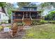 Inviting backyard with a spacious porch, fire pit, and lush greenery at 233 Spence Se Ave, Atlanta, GA 30317