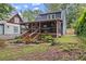 Backyard featuring a screened porch, well-maintained landscaping, and wooded surroundings at 233 Spence Se Ave, Atlanta, GA 30317