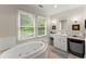 Bright bathroom with a soaking tub, double windows, and modern fixtures at 233 Spence Se Ave, Atlanta, GA 30317