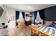Bedroom featuring natural light, wood floors, and dark blue accent wall at 233 Spence Se Ave, Atlanta, GA 30317
