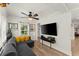 Bright living room with hardwood floors, comfortable seating, and a ceiling fan at 233 Spence Se Ave, Atlanta, GA 30317