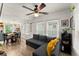 Well-lit living room with large windows, a comfortable sofa, and a view into dining area at 233 Spence Se Ave, Atlanta, GA 30317