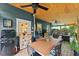 Spacious screened porch with a dining table, refrigerator, and comfortable seating at 233 Spence Se Ave, Atlanta, GA 30317