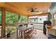 Inviting screened porch with a dining table, ceiling fan, and outdoor refrigerator at 233 Spence Se Ave, Atlanta, GA 30317