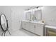Bathroom featuring double vanity with quartz countertops, modern lighting, decorative mirror and marble floors at 3334 Swallowtail Ter, Duluth, GA 30096