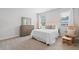 Bedroom with neutral decor, a rocking chair, and large windows for natural light at 3334 Swallowtail Ter, Duluth, GA 30096