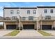 Modern townhome boasts a two-car garage, private decks, and crisp white siding at 3334 Swallowtail Ter, Duluth, GA 30096