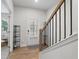 Foyer featuring a hardwood floor and staircase with a wood railing and wrought iron spindles at 3334 Swallowtail Ter, Duluth, GA 30096