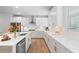 Well-lit kitchen with white cabinets, stainless steel appliances, and a large island at 3334 Swallowtail Ter, Duluth, GA 30096