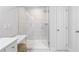 Elegant shower with frameless glass doors, white marble tile, and a seating area at 3334 Swallowtail Ter, Duluth, GA 30096
