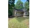 Quaint one-story home with a cozy front deck nestled in a green, lush yard at 5119 Hill Farm Ne Dr, Woodstock, GA 30188