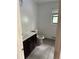 Bathroom with a white sink vanity, toilet, tiled floor, and a window at 6649 Valley Hill Sw Dr, Mableton, GA 30126