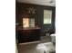 Bathroom featuring a dark vanity, mirror, and a window for natural light at 6649 Valley Hill Sw Dr, Mableton, GA 30126
