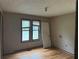 Bedroom featuring hardwood floors, two windows with blinds, and a white door at 6649 Valley Hill Sw Dr, Mableton, GA 30126
