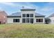 Back exterior of home with a large lawn and many windows looking out to the back at 185 Beracah Sw Walk, Atlanta, GA 30331