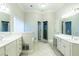Luxurious bathroom with double vanity, soaking tub, white cabinets and large window for natural light at 185 Beracah Sw Walk, Atlanta, GA 30331