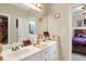 Bathroom with double sinks, white cabinets, and framed mirror at 185 Beracah Sw Walk, Atlanta, GA 30331