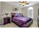 Bedroom features a dark wood bed frame, neutral paint, carpet and a fan at 185 Beracah Sw Walk, Atlanta, GA 30331