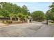 Gated community entrance featuring mature landscaping, a black metal gate, and well-maintained surroundings at 185 Beracah Sw Walk, Atlanta, GA 30331