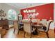 A dining room with hardwood floors, chandelier and red accent wall at 185 Beracah Sw Walk, Atlanta, GA 30331