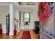 An entryway with hardwood floors, a decorative wreath, and a staircase leading to the second floor at 185 Beracah Sw Walk, Atlanta, GA 30331