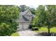 Charming brick home with a two-car garage and lush green landscaping surrounding the property at 185 Beracah Sw Walk, Atlanta, GA 30331