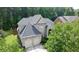 Home exterior showcasing a two-car garage, a beautiful brick facade, and a landscaped front yard at 185 Beracah Sw Walk, Atlanta, GA 30331