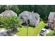 Aerial view of the front exterior with a green lawn, mature trees, and a truck in the driveway at 185 Beracah Sw Walk, Atlanta, GA 30331