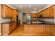 Gourmet kitchen with custom wood cabinets, granite countertops, stainless steel appliances, and hardwood floors at 185 Beracah Sw Walk, Atlanta, GA 30331