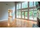 Bright living room with hardwood floors, a fireplace, high ceilings, large windows with a view of the greenery outside at 185 Beracah Sw Walk, Atlanta, GA 30331