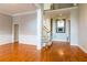 Open-concept floor plan boasts hardwood floors and classic chandelier, with a staircase in the background at 185 Beracah Sw Walk, Atlanta, GA 30331