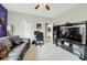Inviting living room with comfortable seating, a dedicated workspace, and a large TV for entertainment at 185 Beracah Sw Walk, Atlanta, GA 30331