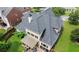 Birds-eye view of the rear exterior featuring a deck, a covered patio, and lush backyard at 185 Beracah Sw Walk, Atlanta, GA 30331