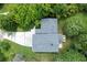 An aerial view of a lovely home with a new gray roof and a cozy deck nestled among mature trees at 2116 Strasburg Ct, Atlanta, GA 30338