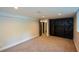 Finished basement includes a closet with dark doors, carpet flooring, and neutral paint at 2116 Strasburg Ct, Atlanta, GA 30338