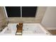 Bathroom featuring a sleek soaking tub with modern fixtures and a built-in tray at 2116 Strasburg Ct, Atlanta, GA 30338