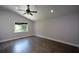 Bright bedroom featuring wood floors, recessed lighting, a ceiling fan, and a large window overlooking a backyard view at 2116 Strasburg Ct, Atlanta, GA 30338