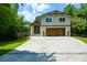 Lovely two-story home featuring stone accents, a modern garage door, and well-manicured landscaping at 2116 Strasburg Ct, Atlanta, GA 30338